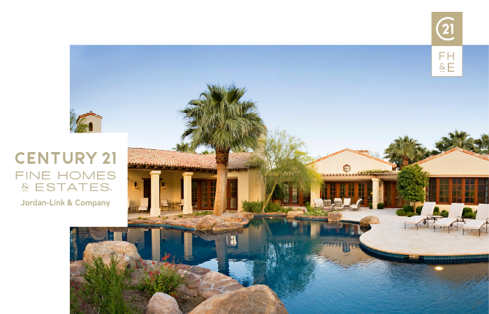 Outdoor view of a lavish home with a pool and palm trees, showcasing the Century 21 Fine Homes & Estates logo